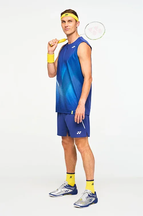 Viktor Axelsen wearing blue Yonex badminton apparel with racket, headband and court shoes